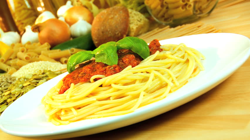 Traditional italian spaghetti bolognese  surrounded by healthy option vegetables & pulses