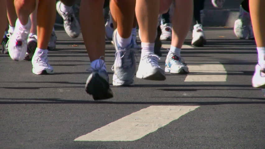 Legs of runners on the city street