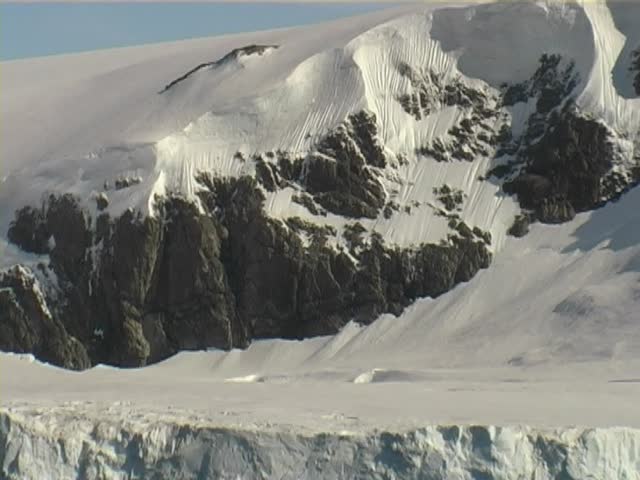 Beautiful snow capped mountains taken at the Antarctic Peninsula from a passenger cruise ship.