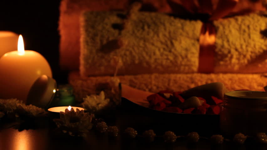 Spa accessories (moisturizer, candles, towels) at therapy center 