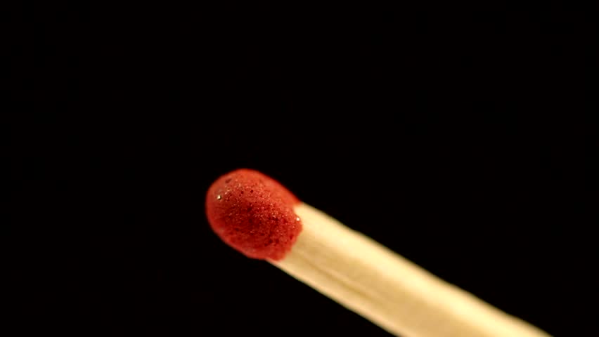 Match lighting and burning till the end and finally disapears from the frame.  Extreme macro shot on black background