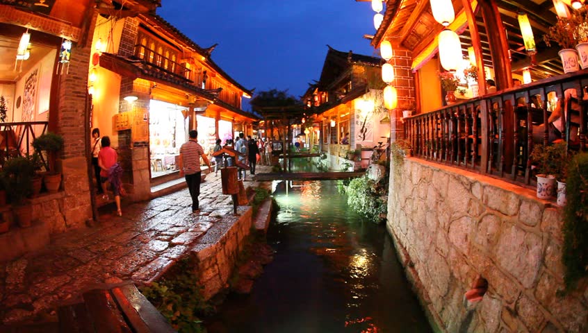 LIJIANG, CHINA - August 20: In the peak of the season, Chinese and world travelers enjoy  old town Lijiang including old architecture, restaurants and the local river, August 20, 2009 in Yunnan.