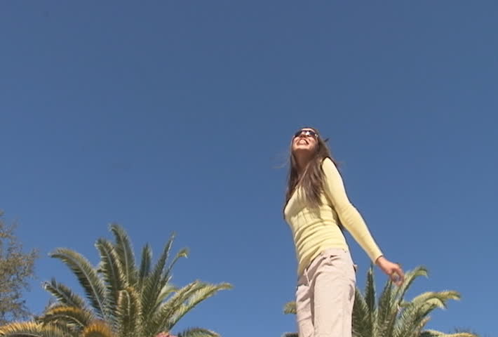 Hispanic woman jumping in the air - slow motion