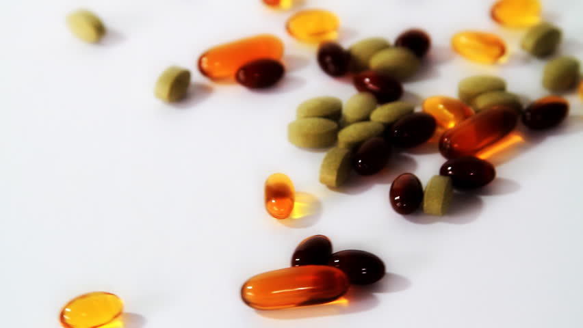 Vitamins rotating on white 