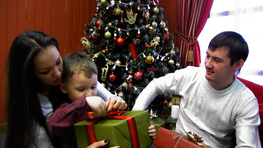 Family Opening Christmas Presents In The Living-room At Home. Footage