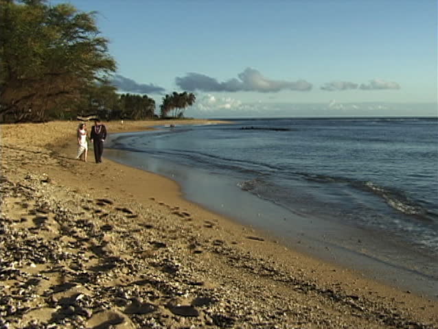 Bride & Groom walk on empty beach