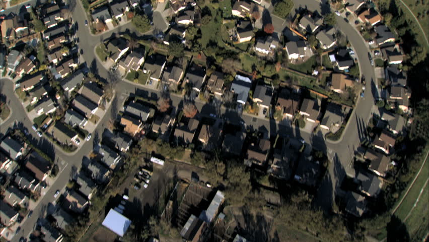 Aerial view of rooftops of housing in city suburbs (slightly shaky)