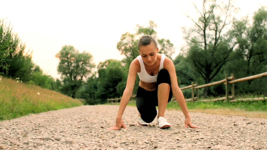 Young woman preparing to run, dolly shot