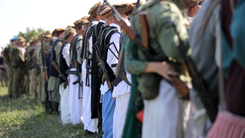 Muslim army. Armed Muslim warriors stand in one line. The background is blurred.