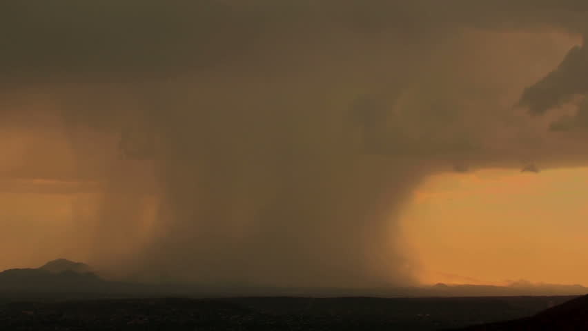 Fantastic time lapse of rain shafts dumping buckets of rain as they move across mountains at sunset. 1920x1080