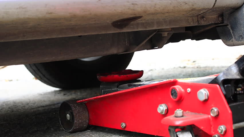 Old Car Sits Offkilter In Car Jack In A Garage Stock Footage Video