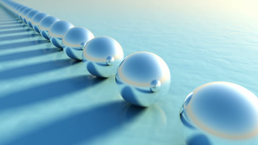A line of uniform metal pearls with a different green one at the end. 