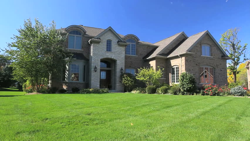 A family walks hand in hand toward their luxury home 