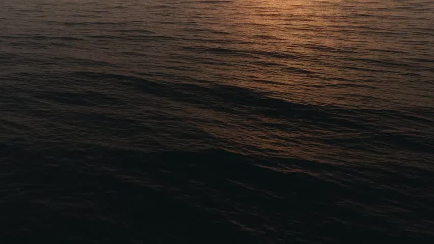 Camera speeding over expansive CG ocean. Slowly tilts up to reveal horizon and sky.
