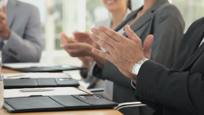 Business Team Applaud at a Meeting