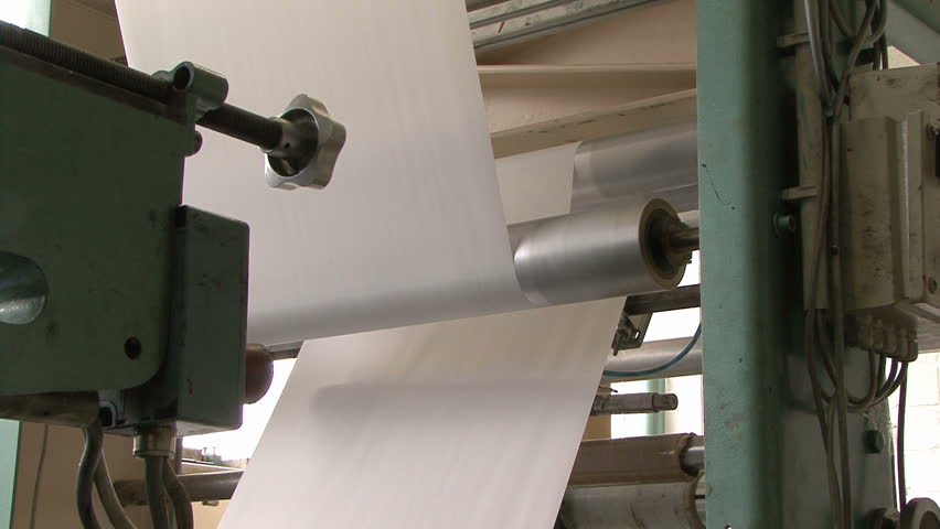 paper rolling through an automated paper bag making and folding assembly machine