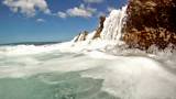 Ocean waves splash into a rocky shoreline before hitting the camera.  Filmed in HD 720.