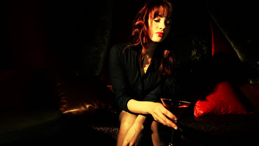 beautiful classic pinup girl in a VIP club drinking a cocktail and dancing