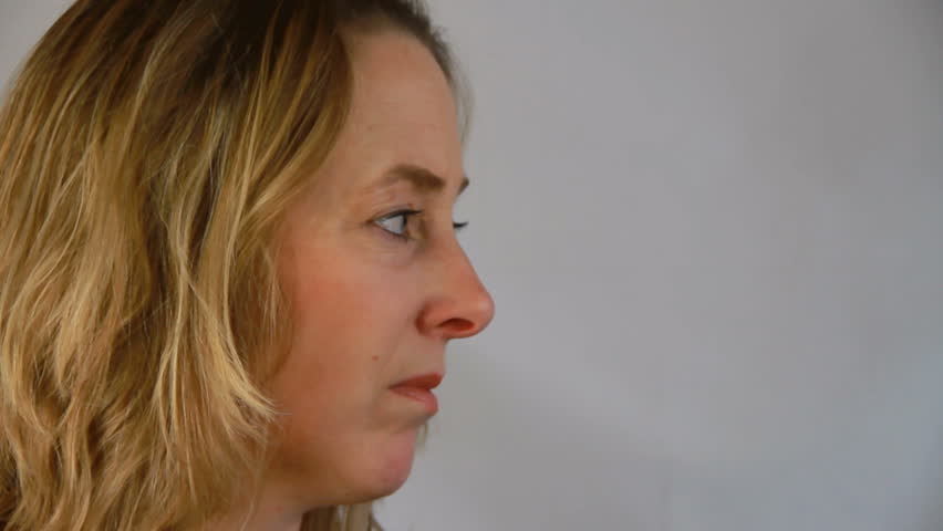 Woman with loose hair turns her head to the camera.