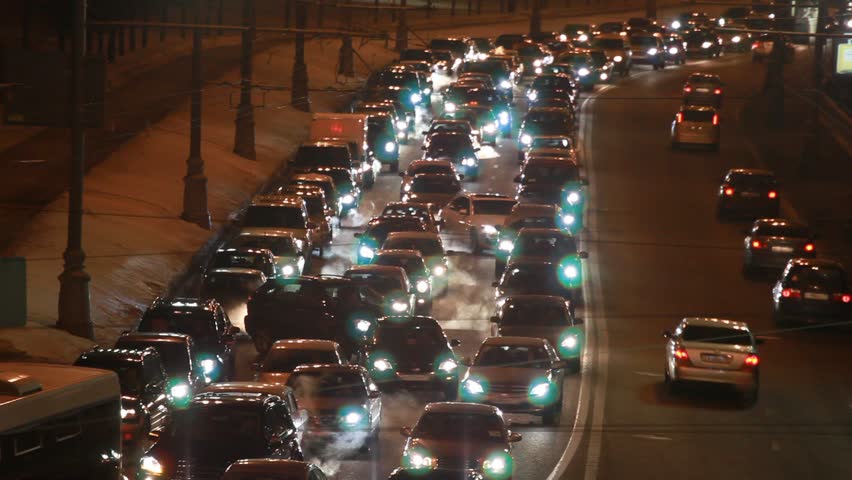 cars in hard traffic jam on wintry street of city at night