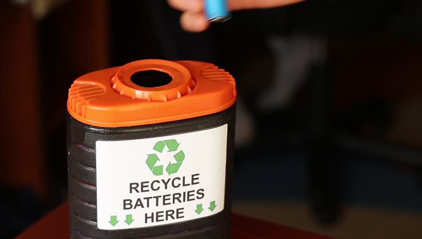 A Recycling Container For Used Batteries. Young Man Places Used ...