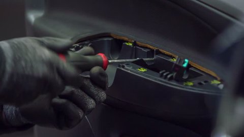 A Mechanic Is Fixing A Door Pull Handle And A Door Open Bezel On A Car In An Automobile Repair Shop