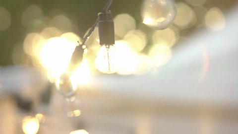 Beautiful Garland Hanging In Slow Motion Outdoors Near Pavilion Tent String Of Lights Glowing And Moving Holiday Decoration And Festival Activity Concept