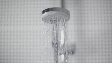 Bathroom Sex Porn 3d - Close-up of turning on and off shower head in bathroom, white tiles with  black pattern on the walls, water flow in front of camera, falling drops in  slow motion