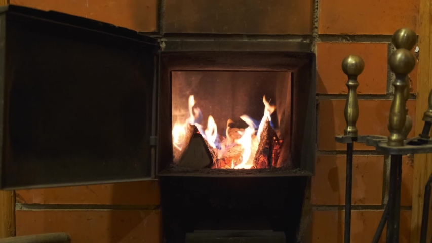 Wood Stove Open Door And Firebox With Fire Is Burning In The Furnace