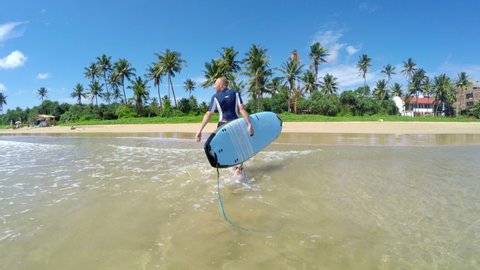 4k Footage Of Surfer Walking Out The Ocean Waves To Sandy Beach With Palms Carrying Surf Board Active Warm Countries Vacation Concept Video