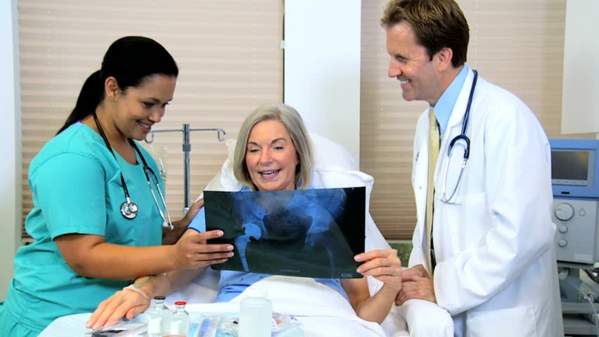 Medical Staff Using Tablet Technology Discussing X Ray Result With Patient Stock Footage Video