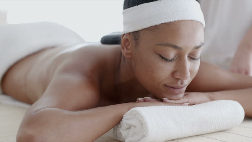 Africanamerican Woman Receiving Massage Hot Stone Stock Footage Video (100% Royalty-free) 13247975 Shutterstock photo