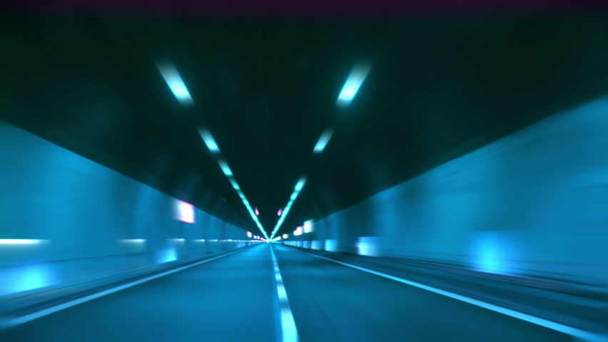Driving through tunnel, abstract with motion blur and glow.