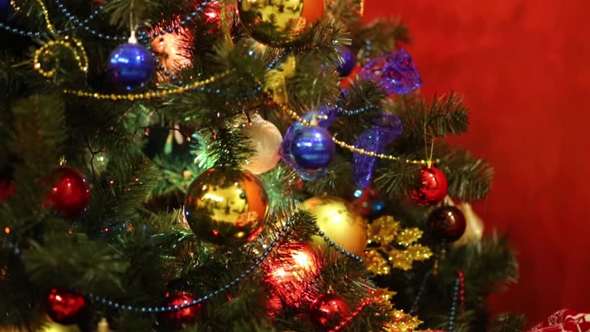 Christmas Tree Lit Colorful Lights On Background Wall In Room, Close-up ...