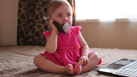 Поговори с малышкой. Детский вербализм. Нет,говорит малышка. Малышка говорит по телефону и смеется. Малышка болтает по телефону на английском.