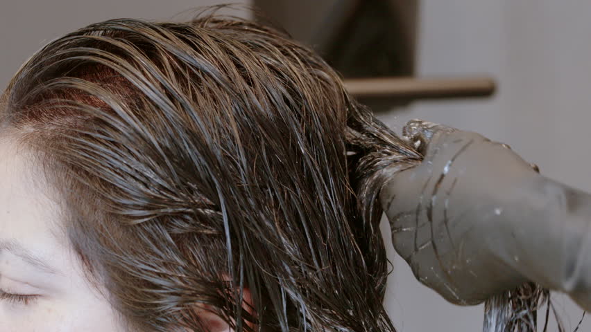 Hairdresser Stylist Working On Bleaching Highlights Into Hair