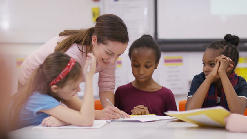 4K Teacher Working With Young Pupils In School Lesson. Shot On RED Epic ...