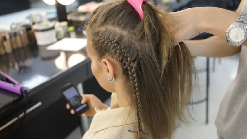 Hd00 08girl Uses Smart Phone In Hairdressers While Hairdresser