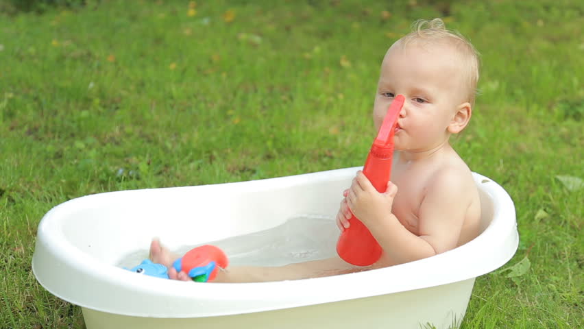 Cute Little Baby Bathed In A Pink Bath Stock Footage Video One Year Old Kid Having A Bath Outdoors And Enjoying It Immensely Hd Stock Footage