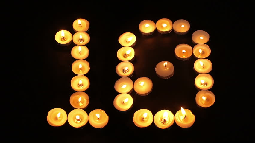 static shot of burning tealight candles arranged like pixel art numeral digits to represent the number - Halloween Background Video static shot of burning tealight candles arranged like pixel art numeral digits to represent the number - Halloween Background Video