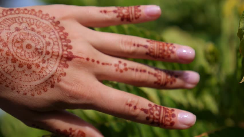 sand through fingers on beach hands with henna tattoo stock sand through fingers on beach hands with henna tattoo stock