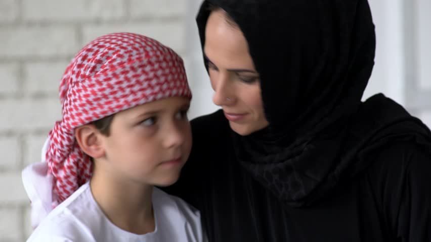 Арабки мать дочь. A boy embracing his mother arab.