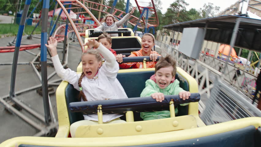 Group Of Kids Shouting While Riding A Roller Coaster Stock Footage ...