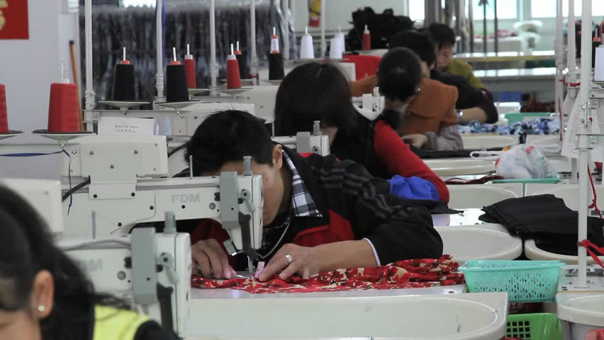 SHENZHEN, CHINA - JUNE 5: Chinese Woman Factory Worker Sewing Black ...