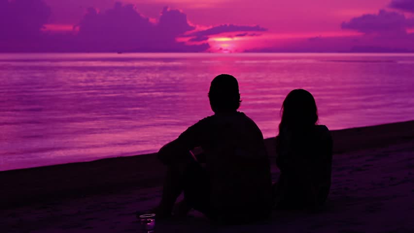 Stock video of silhouette of romantic couple watching sunset