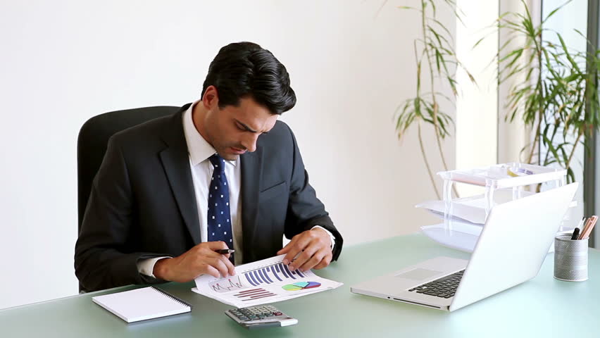 Handsome Businessman Working At His Desk Shot On Red Epic Stock Businessman Working On Doents In His Office Hd Stock Footage Clip