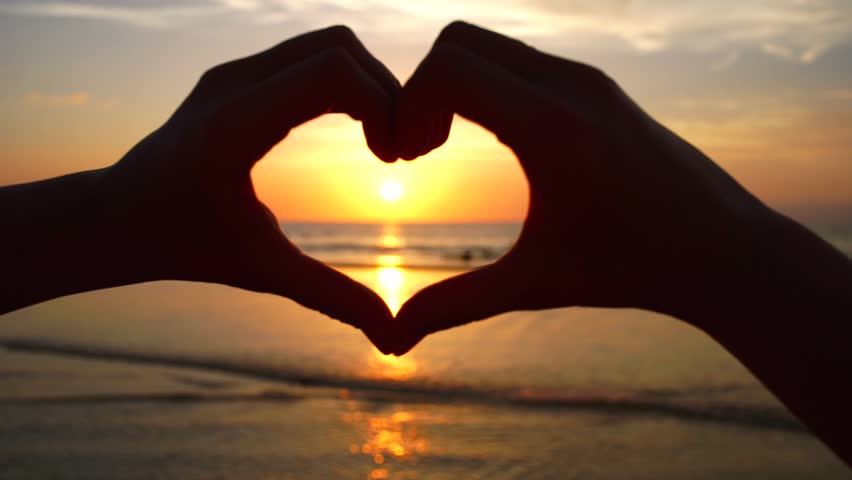 Ocean Sunset Shining Through Heart Shaped Hands Stock Footage Video