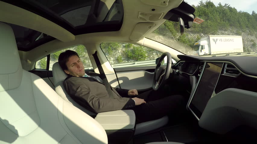 Male Driver Sleeping Behind The Self-driving Steering Wheel Of An ...