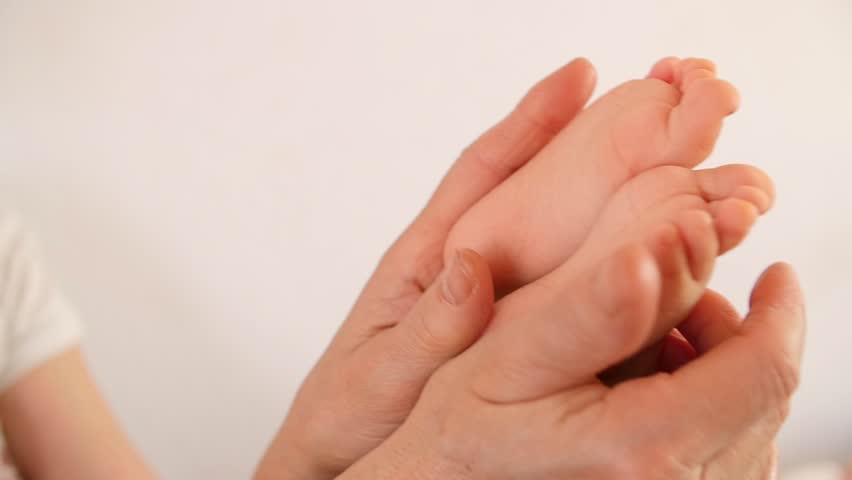 Beautiful Woman Lying Moisturizing Cream On Her Hands Spa And Mother Holding Baby Newborn Feet Slow Motion Close Up Foot Toes Motherly Hd Stock Footage