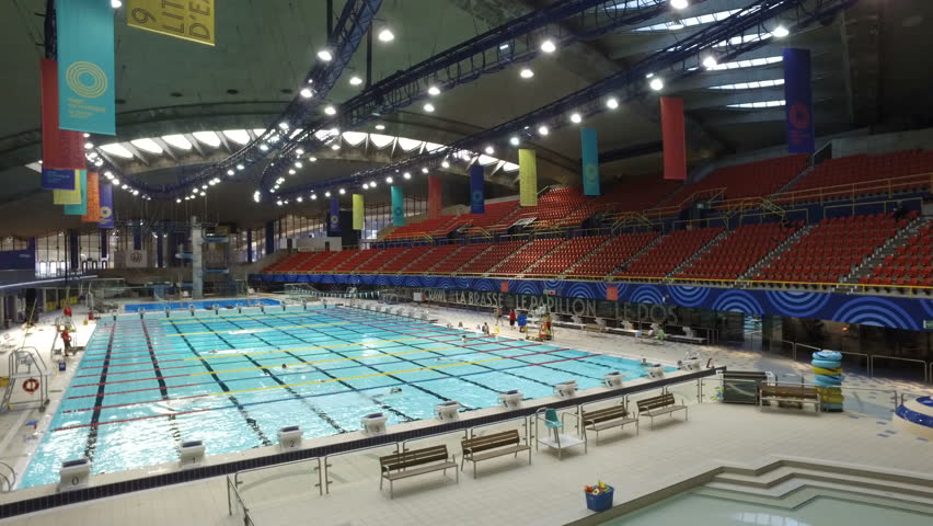 Olympic Swimming Pool 2017 montreal, canada - may 2017: smooth steadicam shot of swimming Olympic Swimming Pool 2017 montreal, canada - may 2017: smooth steadicam shot of swimming